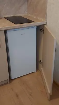 a small white refrigerator under a counter in a kitchen at Aphrodite Park in Sunny Beach