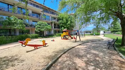 a playground in front of a building at Апартамент Царски бриз in Sozopol