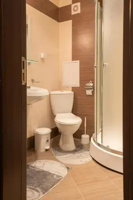 a bathroom with a toilet and a sink and a shower at Апартамент Царски бриз in Sozopol