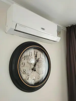 a clock on a wall with a light above it at Afrodita Palas , studio appartment 4 floor, pool view in Sunny Beach