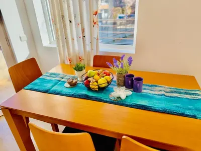 a wooden table with a bowl of fruit on it at Charming 2-bed flat with pool view in Sunny Beach, Bulgaria in Sunny Beach