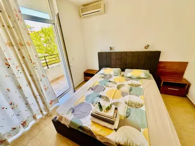 a bedroom with a bed with a window at Charming 2-bed flat with pool view in Sunny Beach, Bulgaria in Sunny Beach