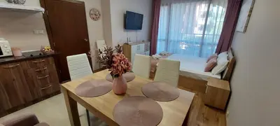 a kitchen and dining room with a table and a room at Студио Ервина in Ravda
