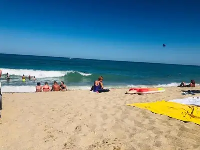 a group of people on a beach with the ocean at Sunny beach apartaments in Sunny Beach