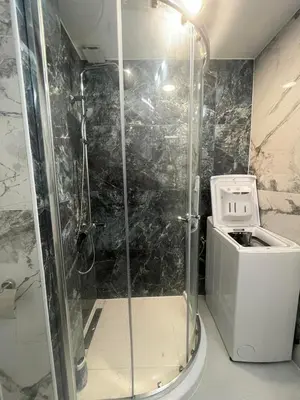 a shower stall in a bathroom with a toilet at Studio 