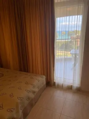 a bedroom with a bed next to a window at Midia Family Resort, Aheloy in Aheloy