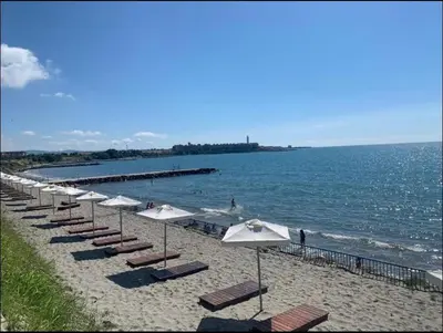 a row of umbrellas and chairs on a beach at Midia Family Resort, Aheloy in Aheloy