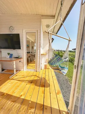 a porch with a hammock in a house at каравани Дрийм Арапя in Tsarevo