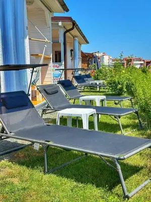 a row of empty picnic tables in the grass at каравани Дрийм Арапя in Tsarevo