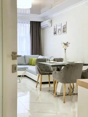 a living room with a table and a couch at Sea View Apartment with Free Parking in Pomorie