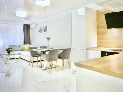 a kitchen and living room with a table and chairs at Sea View Apartment with Free Parking in Pomorie