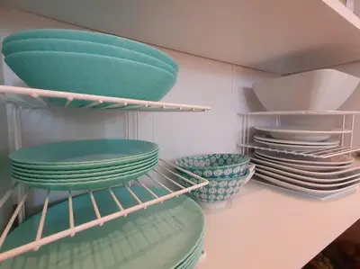 a bunch of plates and bowls on a shelf at Sunset Dreams apartment in Burgas City