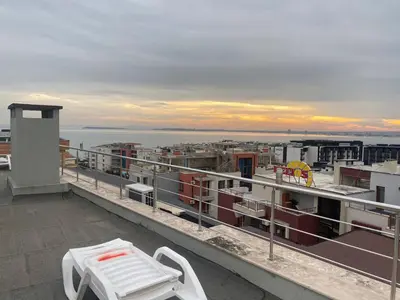 a balcony with a table and a bench on a building at Studio Sveti Vlas 