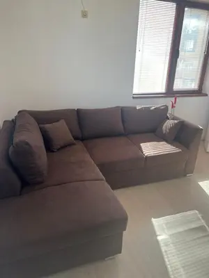 a brown couch sitting in a living room at Частен апартамент Стамополу - Private Two-Bedroom Apartment Stamopolu in Primorsko