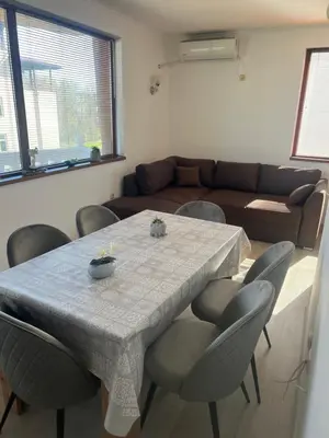 a living room with a table and chairs and a couch at Частен апартамент Стамополу - Private Two-Bedroom Apartment Stamopolu in Primorsko