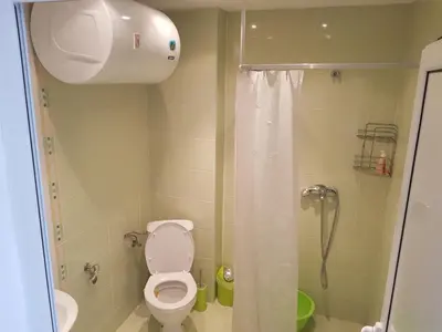 a bathroom with a toilet and a shower at Midia Grand Rezort in Aheloy