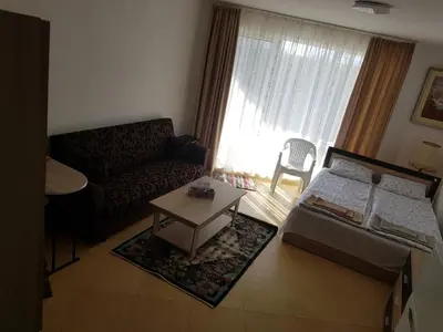 a living room with a couch and a table at Midia Grand Rezort in Aheloy