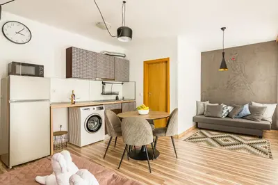 a kitchen and living room with a table and a couch at Todorka Sunny View Central w Słonecznym Brzegu in Sunny Beach
