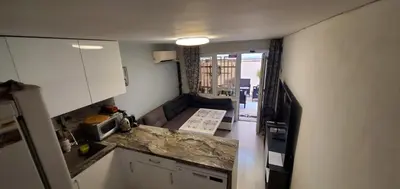 a small kitchen with a counter top and a refrigerator at DELUXE TOP CENTER House with garden's tent ,2 bedrooms and living room next to the BEACH and SEA GARDEN- 5 min by walk,with equiped kitchen in Burgas City