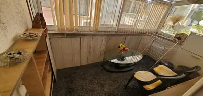 a small room with a table and chairs and a window at DELUXE TOP CENTER House with garden's tent ,2 bedrooms and living room next to the BEACH and SEA GARDEN- 5 min by walk,with equiped kitchen in Burgas City