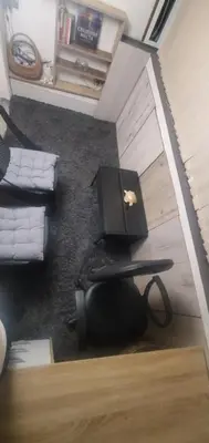 a living room with a laptop computer on a table at DELUXE TOP CENTER House with garden's tent ,2 bedrooms and living room next to the BEACH and SEA GARDEN- 5 min by walk,with equiped kitchen in Burgas City