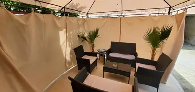 a tent with chairs and a table in a room at DELUXE TOP CENTER House with garden's tent ,2 bedrooms and living room next to the BEACH and SEA GARDEN- 5 min by walk,with equiped kitchen in Burgas City