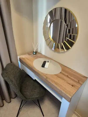 a mirror and a desk with a chair and a table at The White House in Nesebar