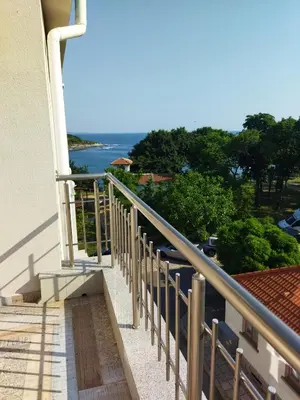 a balcony of a house with a view of the ocean at Сити бийч вю in Tsarevo