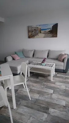 a living room with a couch and a table and chairs at Сити бийч вю in Tsarevo
