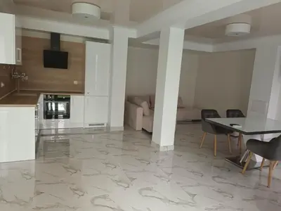 a kitchen and living room with a marble floor at Apartment Ground Floor in Pomorie