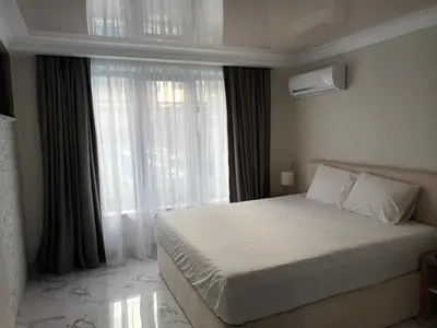 a bedroom with a bed and a large window at Apartment Ground Floor in Pomorie