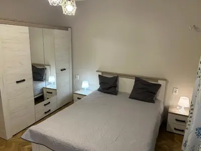 a bedroom with a bed and a large mirror at Niya Apartment Bourgas in Burgas City