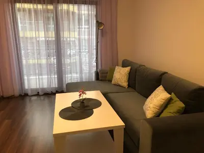 a living room with a couch and a coffee table at Purple Rose Apartment Valencia Gardens in Nesebar