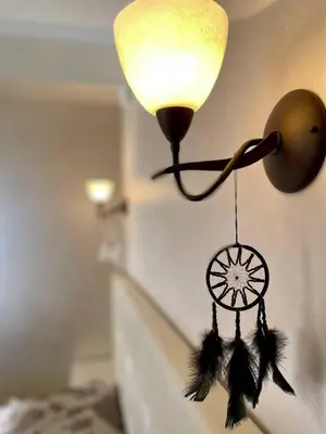 a lamp with a dream catcher on a wall at Luxurious 2 BR Appt at the Black Sea Coast in Sunny Beach
