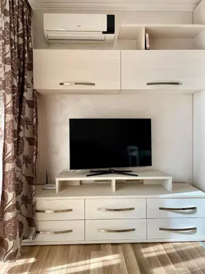 a large white entertainment center with a flat screen tv at Luxurious 2 BR Appt at the Black Sea Coast in Sunny Beach