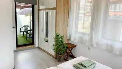 a room with a bed and a window and a table at ETARA 2, Sveti Vlas - APARTELLO⊛com in Sunny Beach