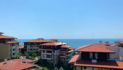 a group of buildings with red roofs and the ocean at ETARA 2, Sveti Vlas - APARTELLO⊛com in Sunny Beach