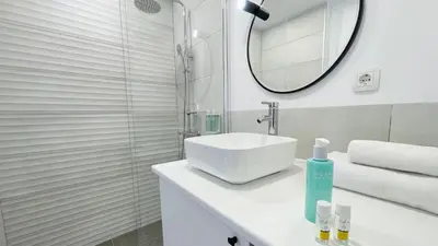 a white bathroom with a sink and a mirror at ETARA 2, Sveti Vlas - APARTELLO⊛com in Sunny Beach