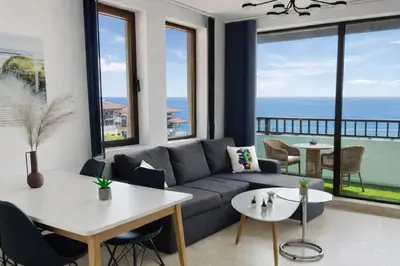 a living room with a couch and views of the ocean at ETARA 2, Sveti Vlas - APARTELLO⊛com in Sunny Beach