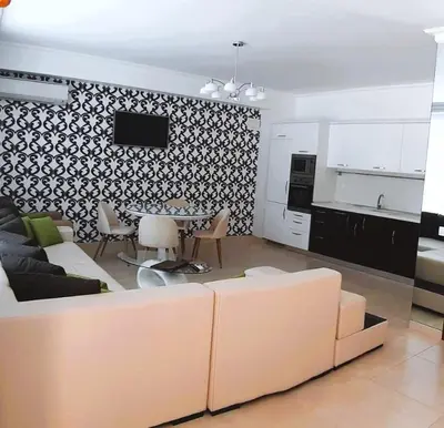 a living room with a couch and a table at Апартамент в Комплекс Милениум in Pomorie