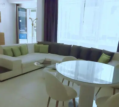 a living room with a couch and a table at Апартамент в Комплекс Милениум in Pomorie