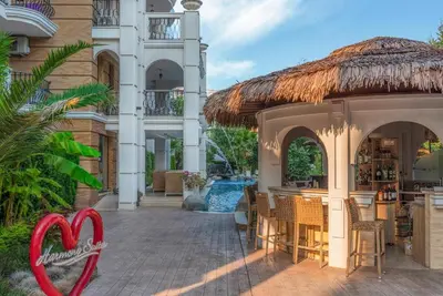 a resort with a swimming pool and a restaurant at Harmony Suitеs apartment in Sunny Beach