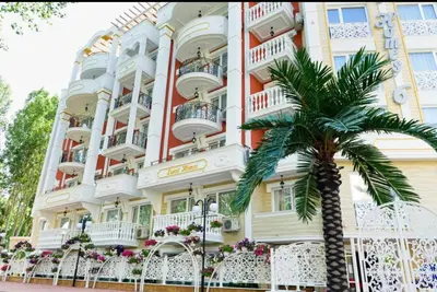 a building with a palm tree in front of it at Sunny studio in Sweet Home Complex in Sunny Beach
