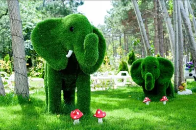a green elephant and a bear standing in the grass at Sunny studio in Sweet Home Complex in Sunny Beach