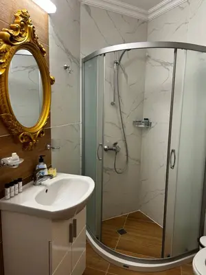 a bathroom with a shower and a sink and a mirror at Sunny studio in Sweet Home Complex in Sunny Beach