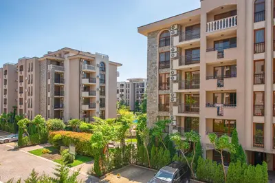 an apartment complex with tall buildings and trees at Cascadas Holiday Apartments in Sunny Beach