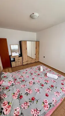 a bedroom with a large bed with a floral bedspread at Fantastic Apartment in Sveti Vlas in Sveti Vlas