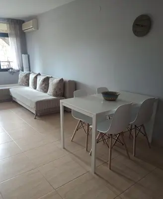 a white table and chairs in a living room at Two room apartment in Etara 3, Sveti Vlas in Sveti Vlas