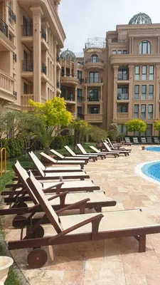 a row of lounge chairs in front of a building at Апартамент под наем С208 в Афродита Гарденс in Sunny Beach
