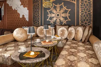 a living room with a couch and two tables at Paradiso Dreams Hotel in Nesebar